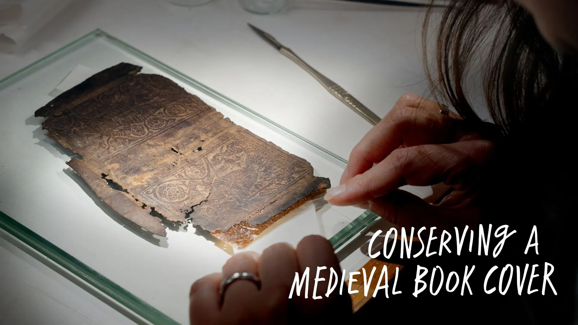Leather Book Cover being conserved. Secrets of the Thames exhibition, 2025-2026.  Object ID: 2024.33