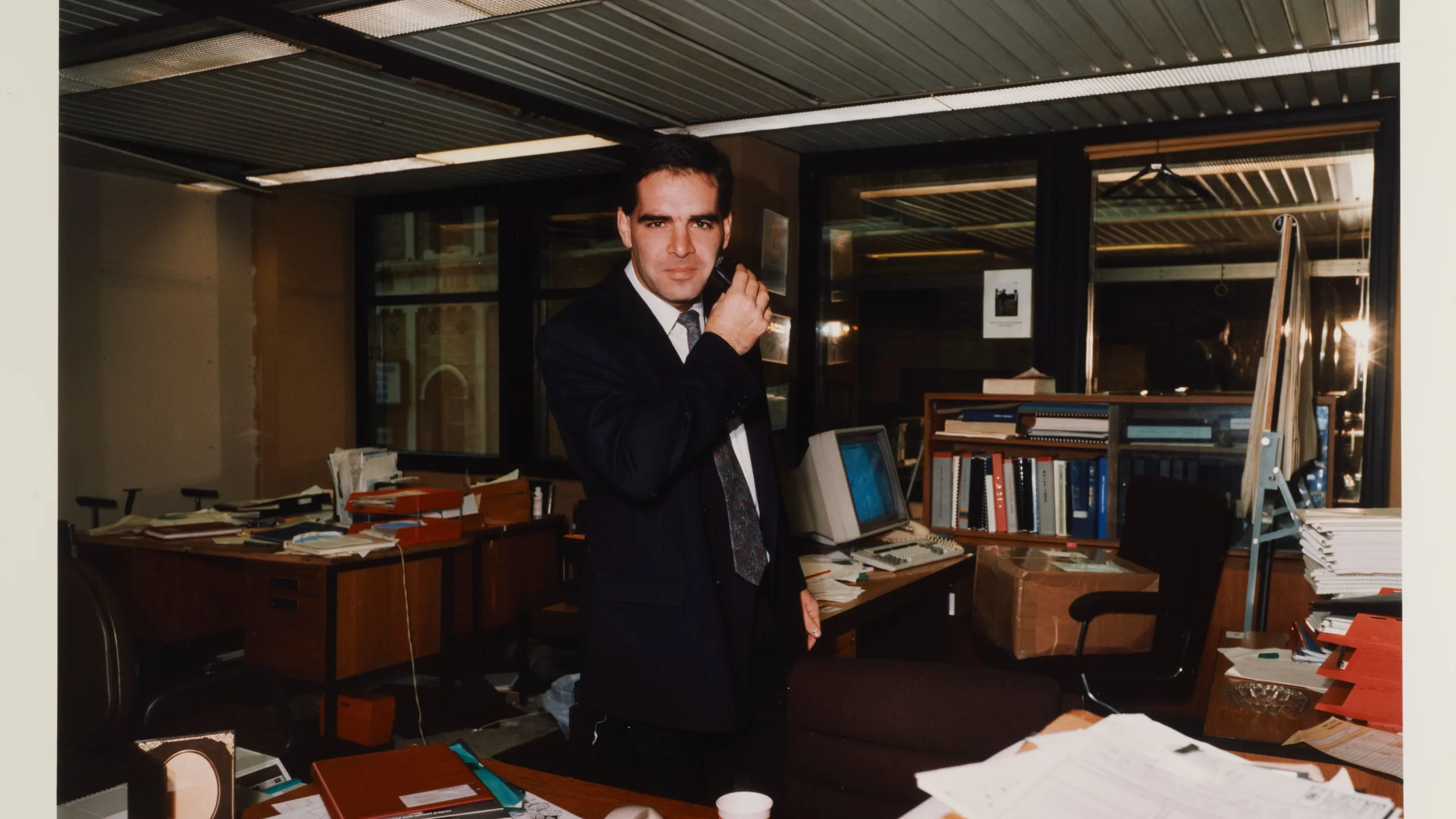 Man in a suit in an office environment (description).