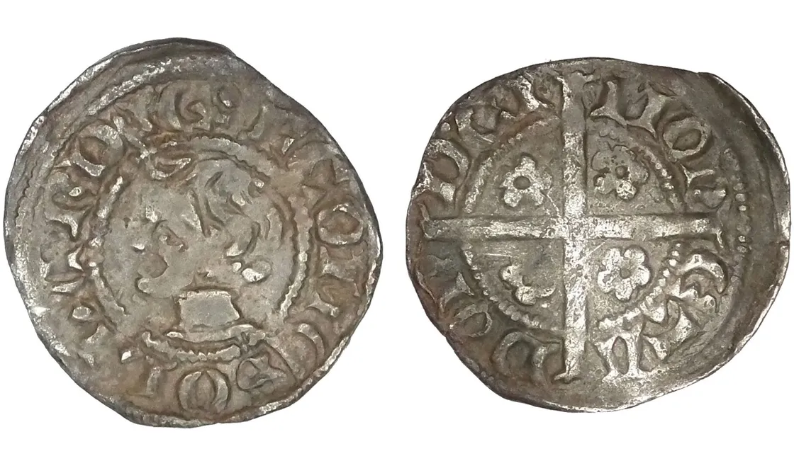 Obverse and reverse sides of an old, worn silver coin featuring inscriptions around the edge; one side shows a crowned head, the other a long cross with decorative details.