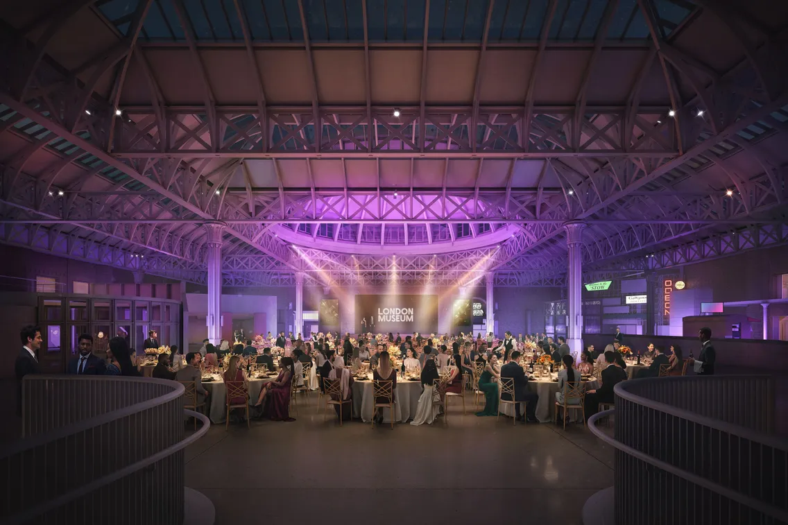 Interior of a domed building with purple lighting and guests sat in a cabaret style