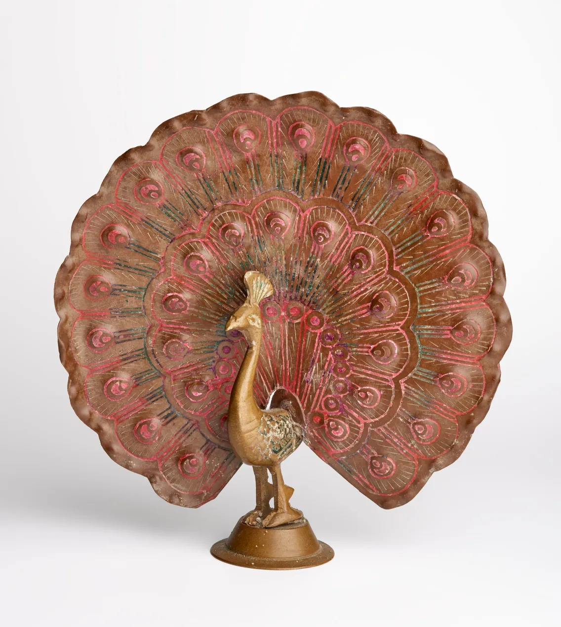 Bronze and red decorative peacock figurine with a large, detailed fanned tail, displayed against a plain white background.