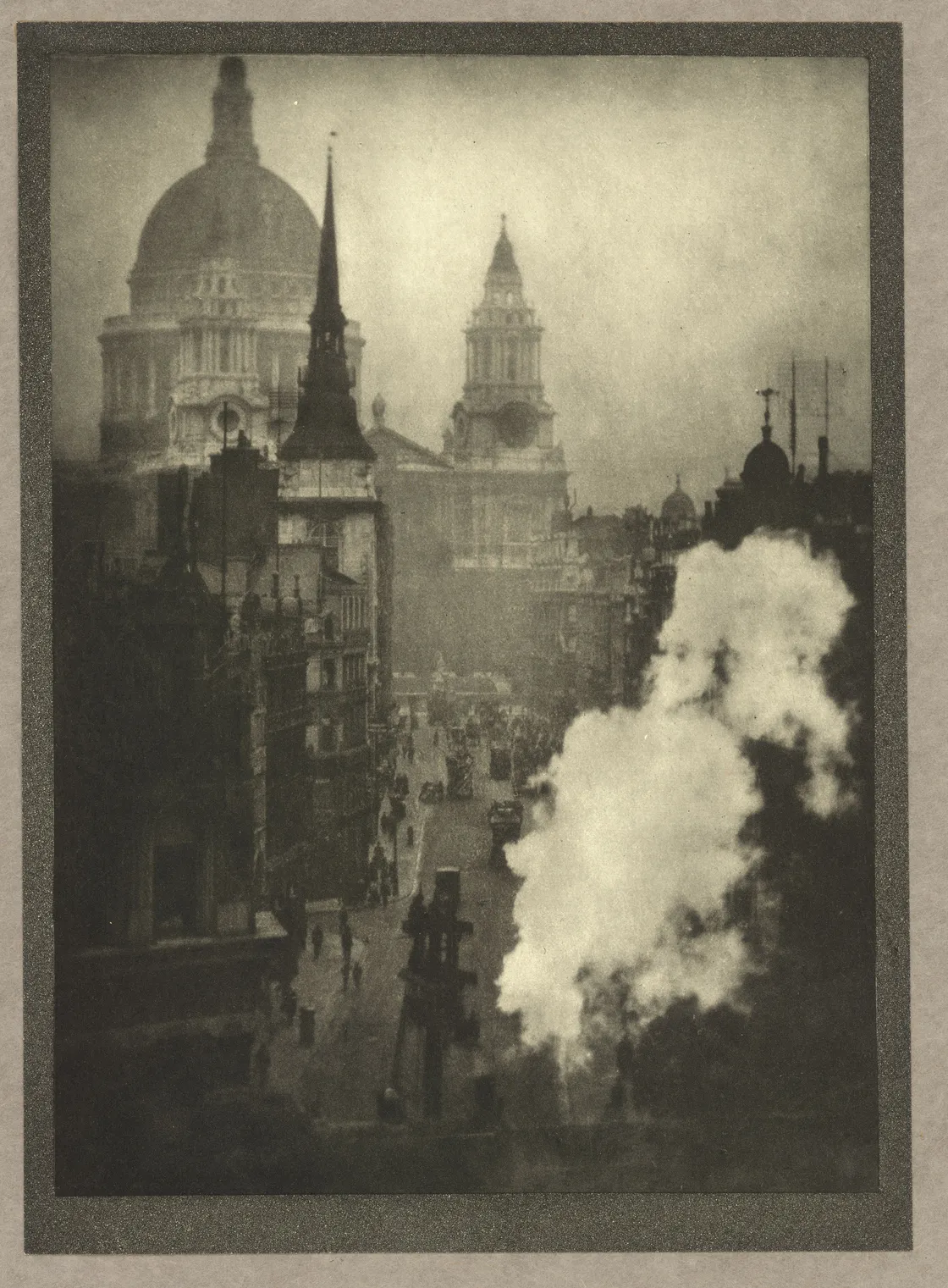 Vintage sepia-toned photo of a busy street with early 20th-century architecture, prominent domed buildings, and a puff of steam in the foreground.