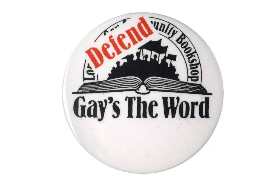 Button featuring the slogan "defend gay's the word" with an image of a book, emphasizing support for the lgbtq+ community.