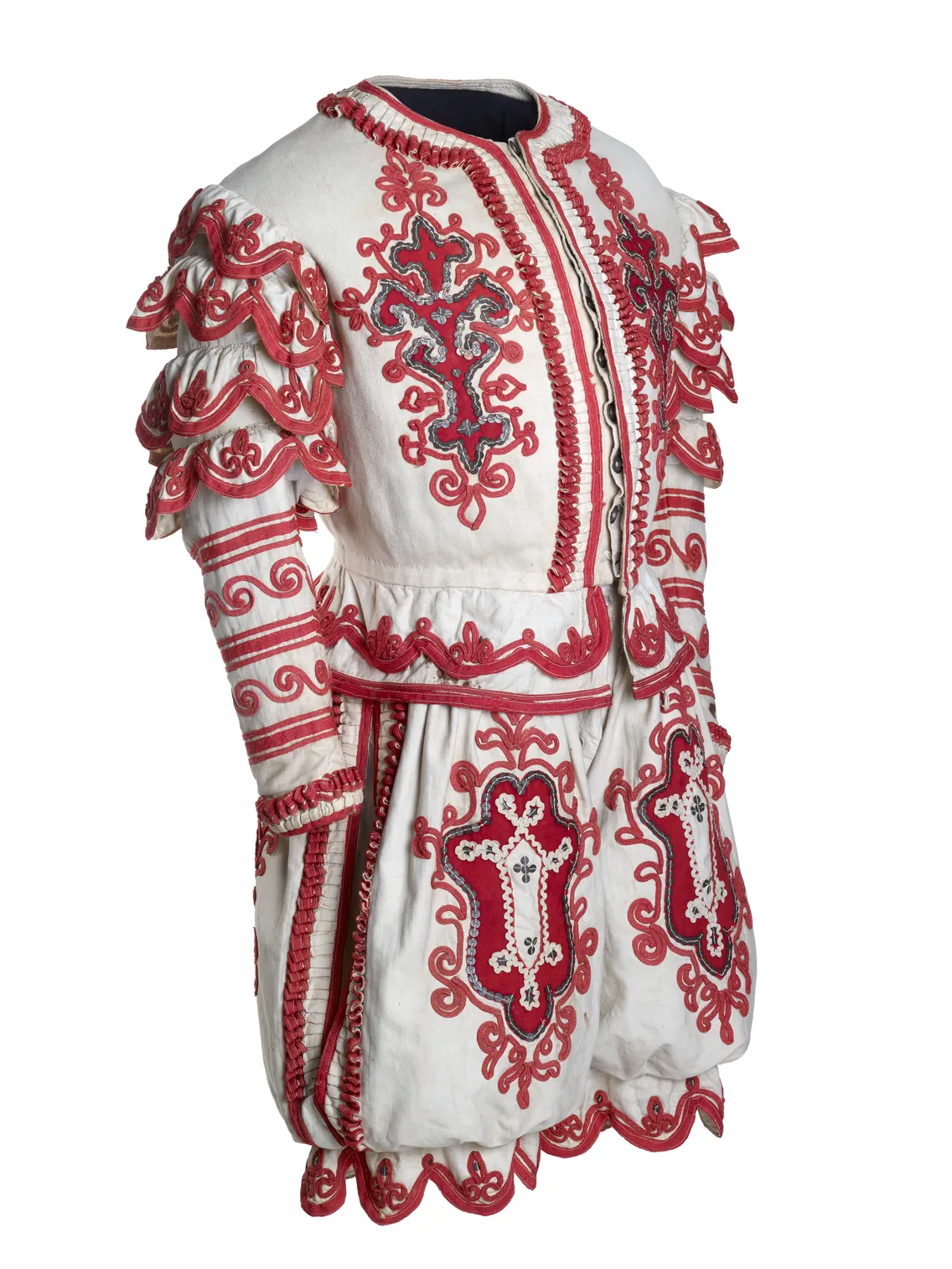 Traditional eastern european folk costume, intricately embroidered with red and silver designs, displayed on a mannequin against a white background.