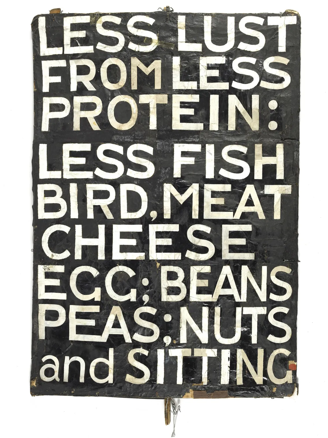 A vintage-looking hand-painted sign with text about reducing consumption of protein sources like fish, bird, meat, and cheese, and promoting beans, peas, nuts, and sitting.