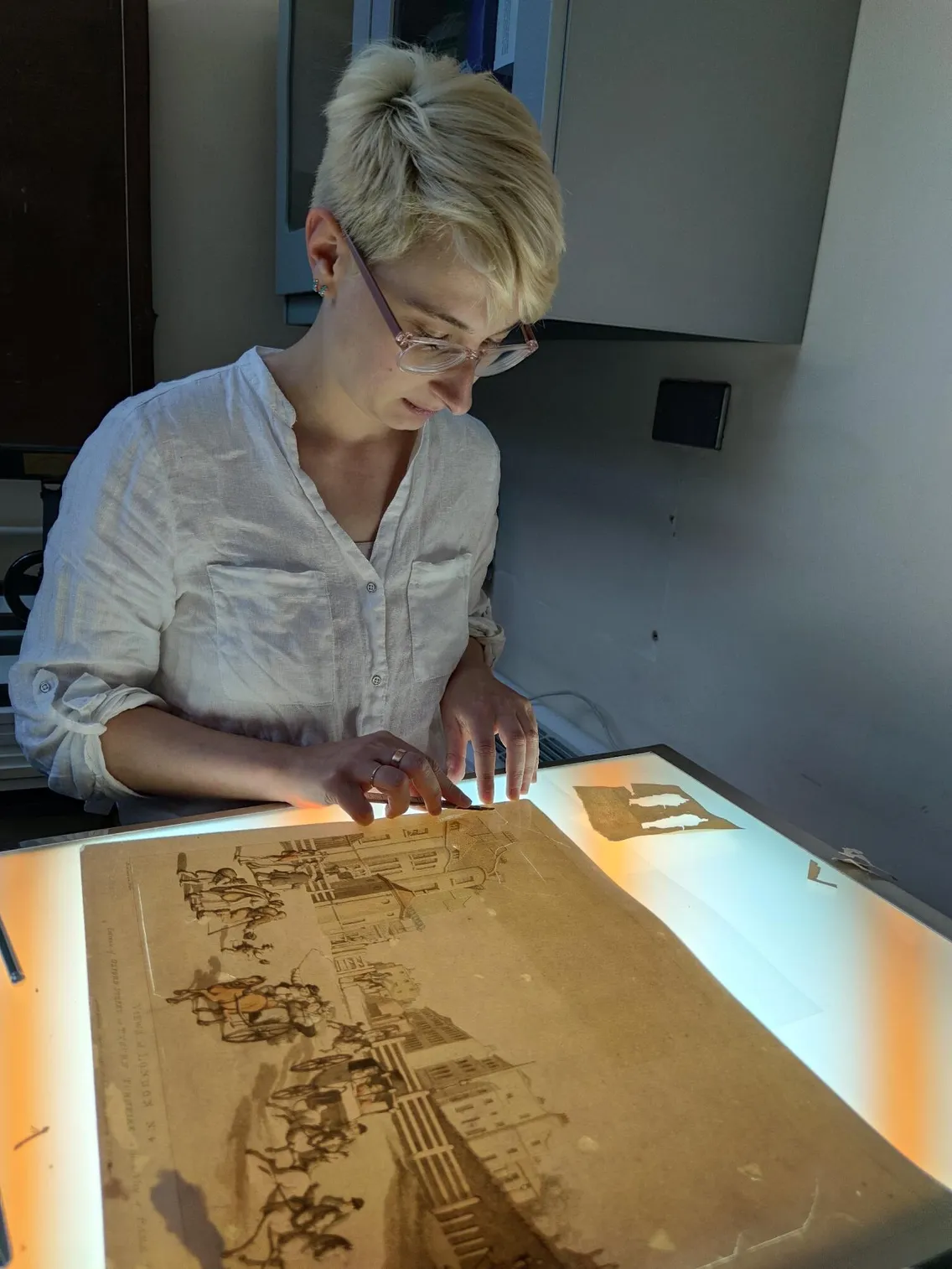 A Conservator working on a paper object treatment for New Museum