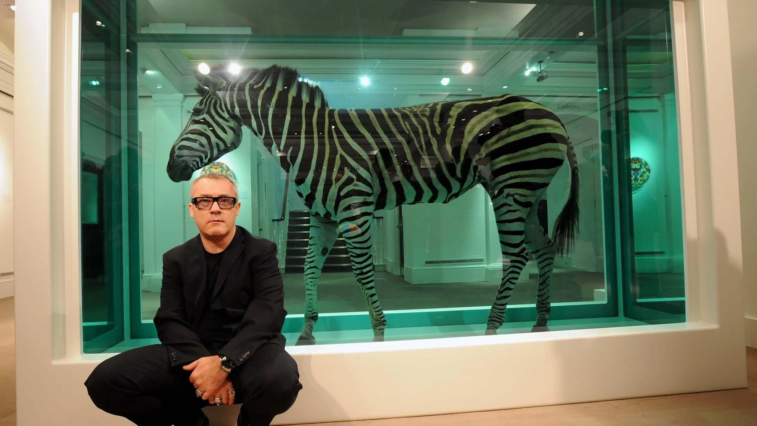 GB4NNT Damien Hirst with one of his works, The Incredible Journey, a zebra in formaldehyde estimated at around 3 million on display at Southeby's in London.