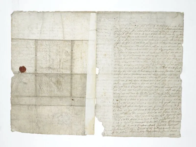 Ancient document with handwritten text in faded ink, featuring a red wax seal. The paper is worn and has visible fold marks, split into two main sections.