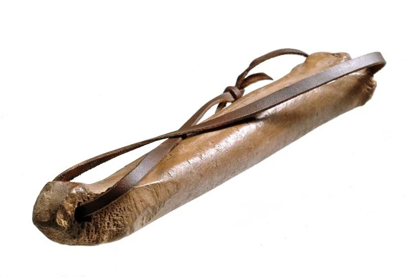 Antique leather scroll case with a strap, isolated on a white background.