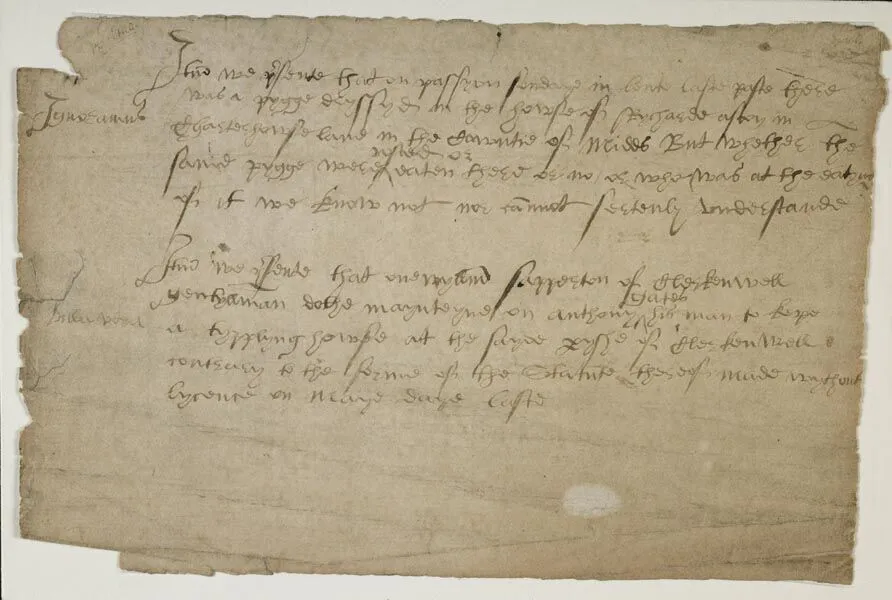 A tattered historical paper document with fine black handwriting.