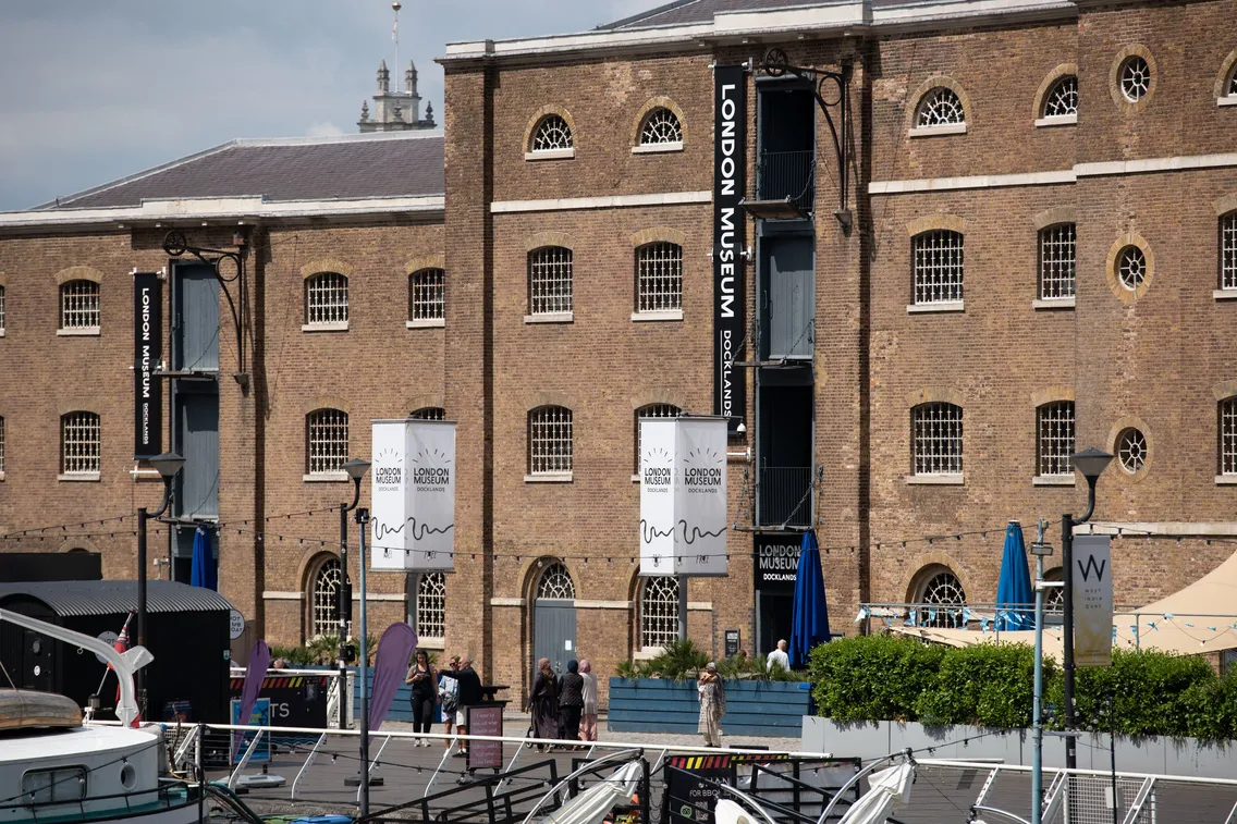 Exterior view of the London Museum Docklands with the Knocker White boat in the foreground.