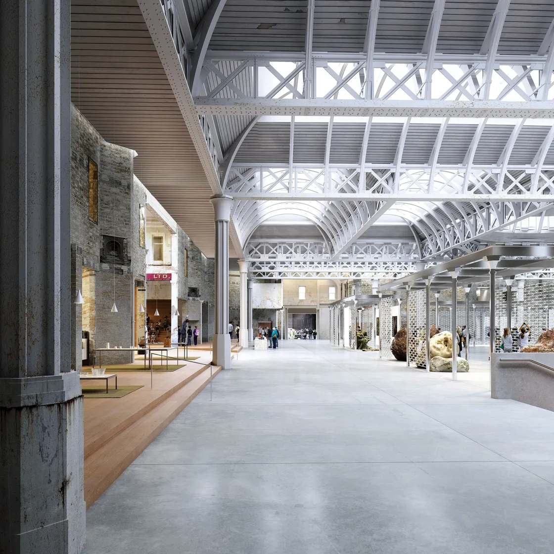 Spacious interior of a modern industrial building with high ceilings and large windows, housing an exhibition with various artworks and displays. People are walking and viewing the installations.