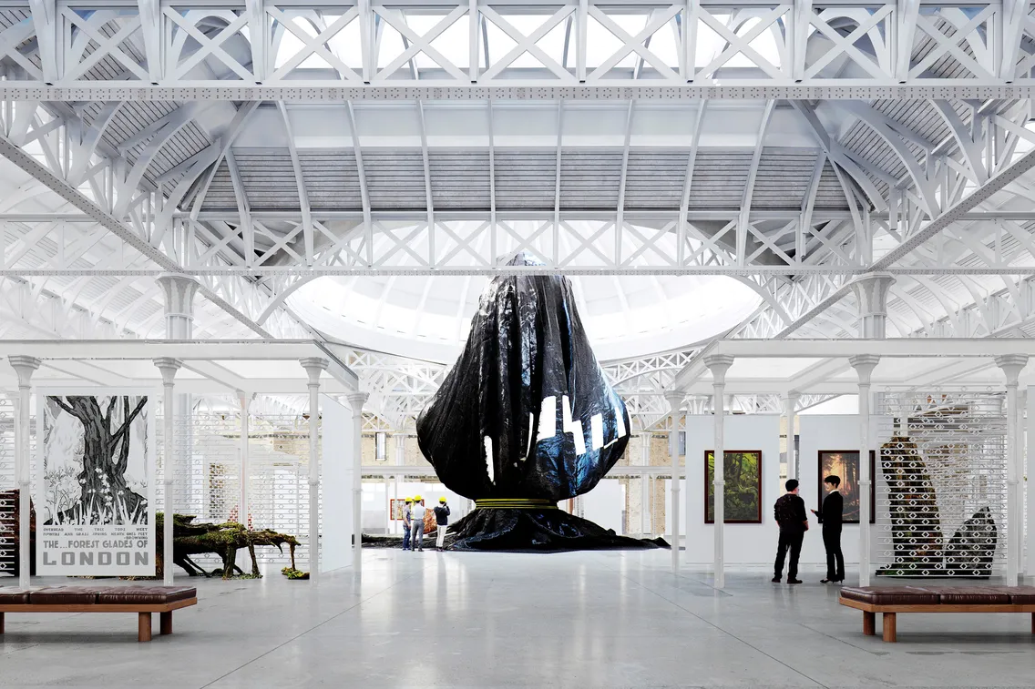 A large black sculpture is displayed at the center of a spacious gallery with a high glass ceiling and white metal framework. Several people observe the artwork and other installations around the room.