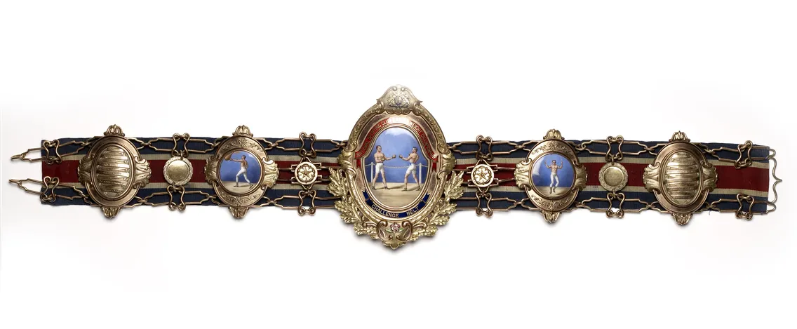 Ornate ceremonial belt featuring multiple gemstones, gold embossing, and a central cameo depicting a classical scene.