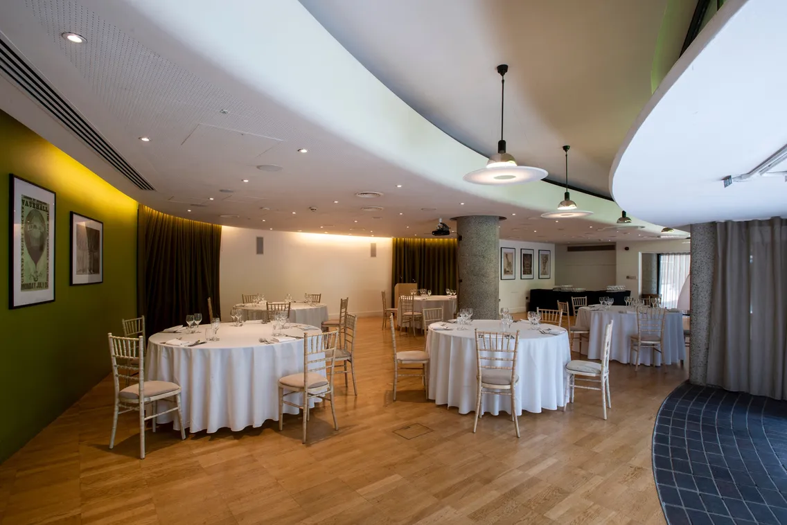 Dressed white tables and chairs in a small conference room