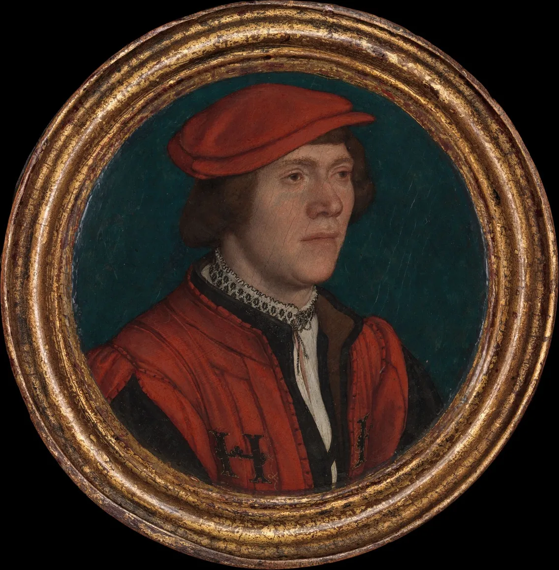A portrait of a man wearing a red hat and red clothing with a blue-green background, encased in an ornate gold frame.