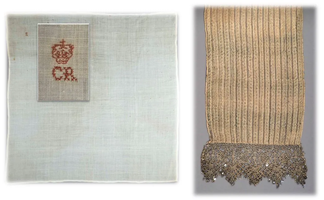 A white handkerchief, embroidered with CR and a crown, next to a gold sash.