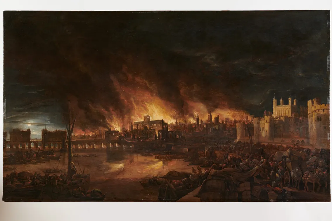A nighttime scene depicts a large fire engulfing buildings along a riverbank.
