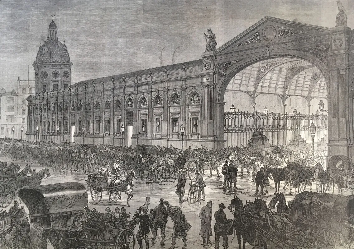 A crowded 19th-century train station with horse-drawn carriages, people, and luggage. The station has an ornate archway and extensive architectural details.