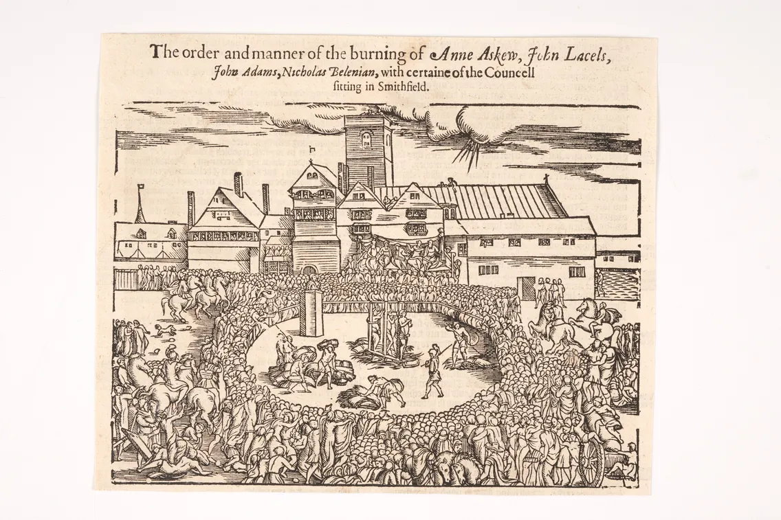 A woodcut illustration depicting the burning of individuals including Anne Askew and John Lacels in Smithfield, with a large gathered crowd and a detailed background of buildings and a tower.