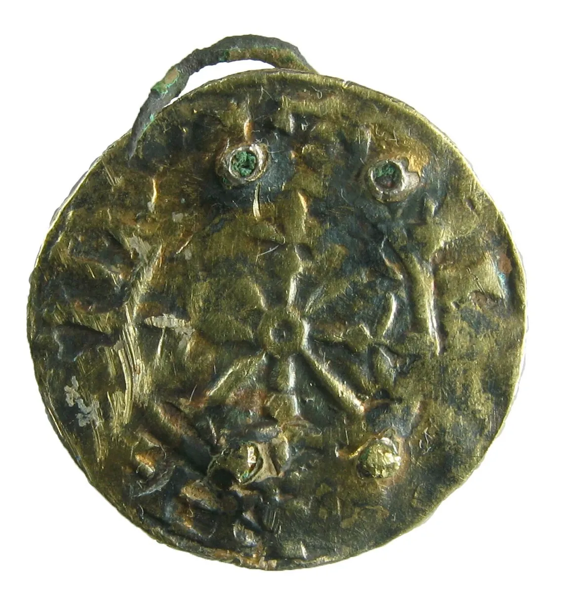 An old round silver coin featuring a flower design at the centre against a white background.